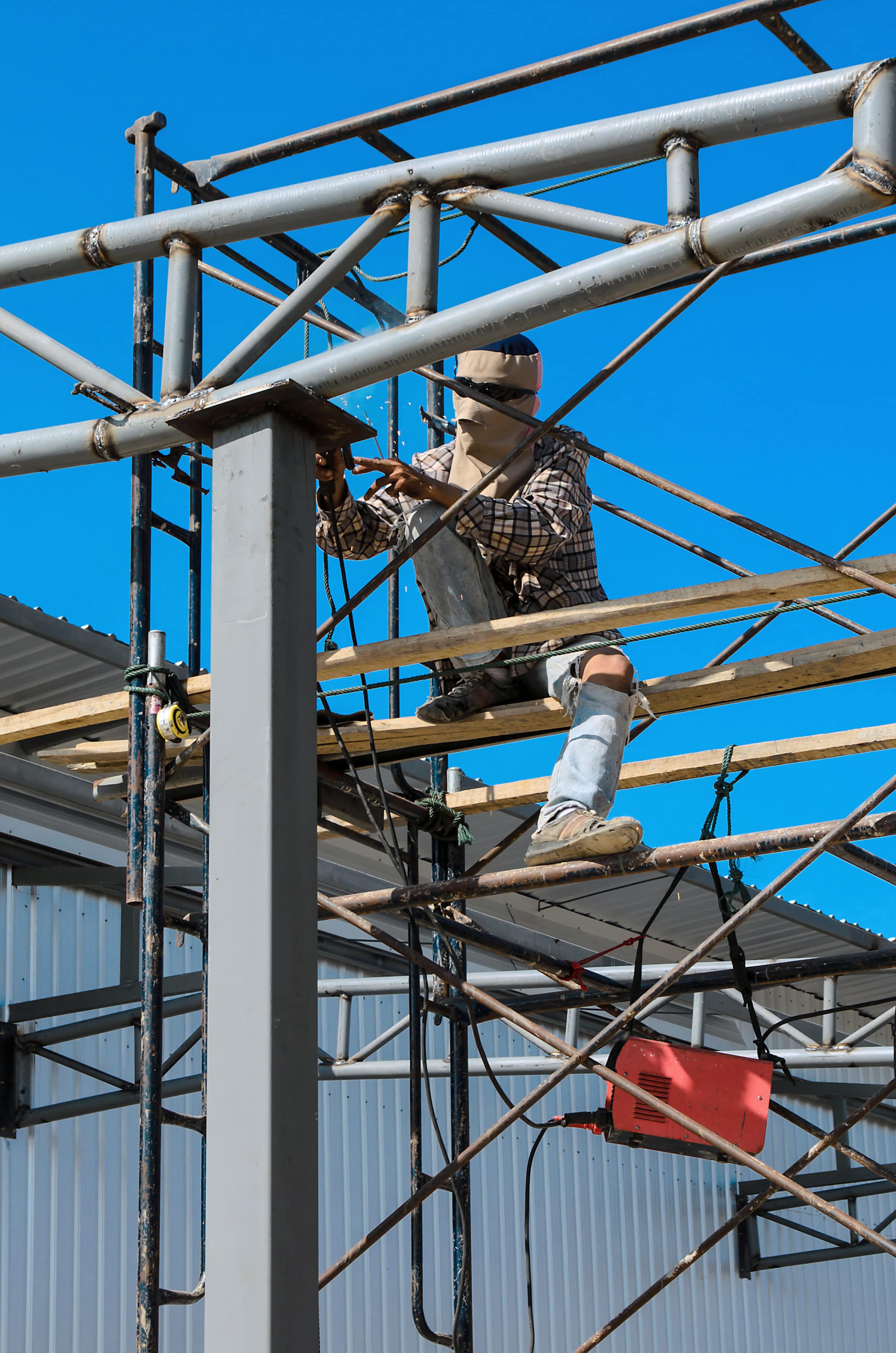 Workers welding steel structures with hight area